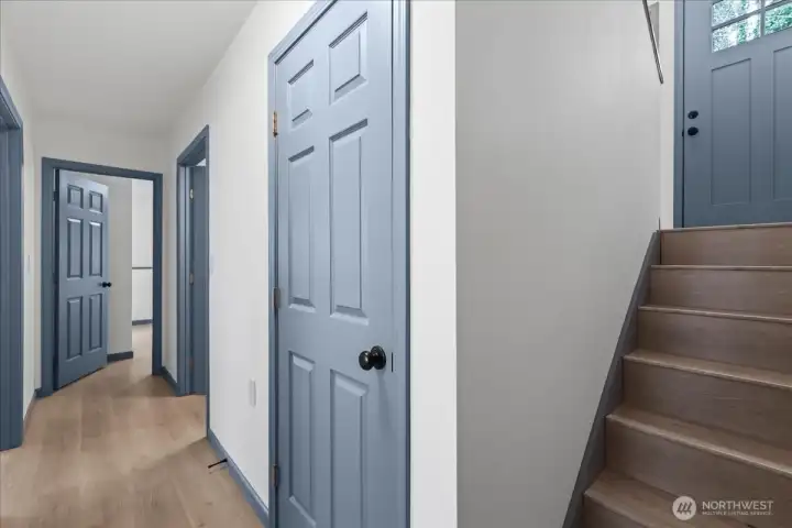 Lower level, garage entry directly behind this POV. Large closet to the right, utility room to the left. After that it's the bathroom on the right, family room on the left, and 3rd bedroom at the end.