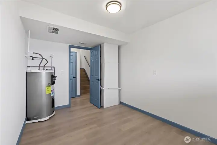 Standing in the corner of the utility room, notice the stairs beyond, garage entry door is straight out of the room and to the right.