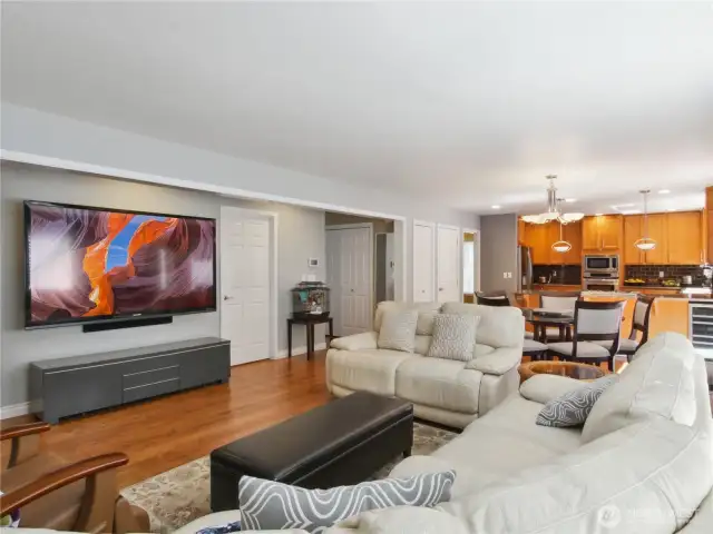 This family room, dining room, and kitchen boast an open-concept design, creating a welcoming and inviting atmosphere.