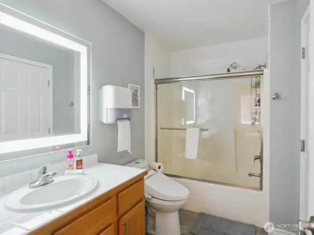 A modern and accessible ensuite bathroom, featuring a bathtub and shower, enhances the comfort and main floor suite convenience.