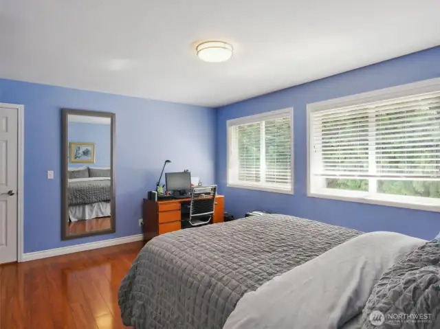 The most spacious of the hallway bedrooms boasts a nook ideal for a personal exercise area or a dedicated hobby corner.