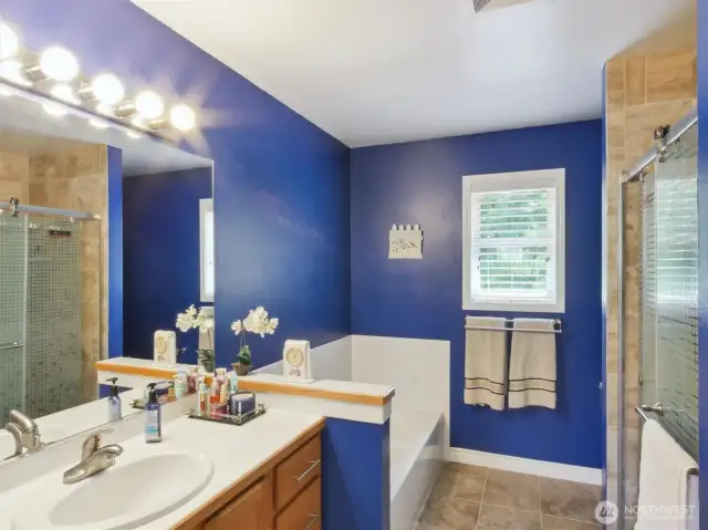 Offering convenience and comfort, the hallway bathroom features distinct shower and bathtub areas.