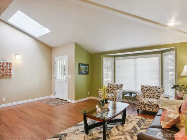Welcoming bright and airy living room with vaulted ceilting.