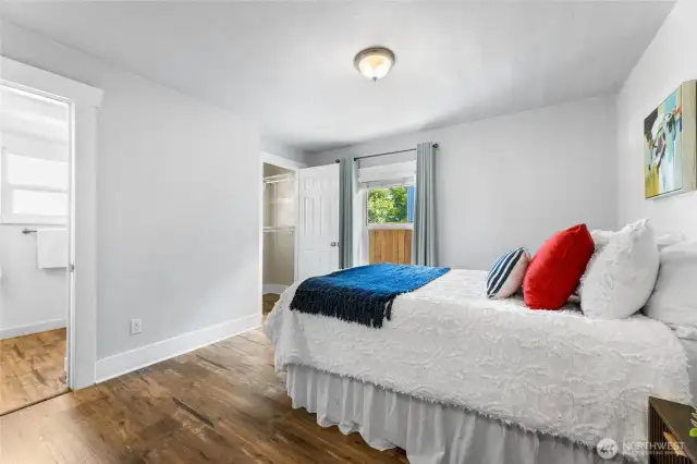 Primary bedroom with walk in closet and bath with walk-in shower