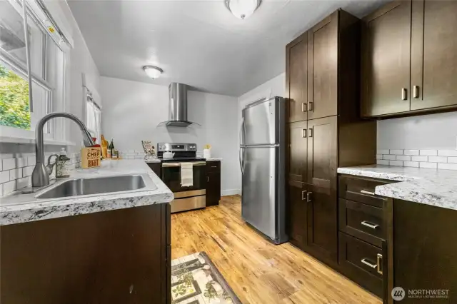 Stunning, updated kitchen with stainless appliances, lots of cabinetry and storage