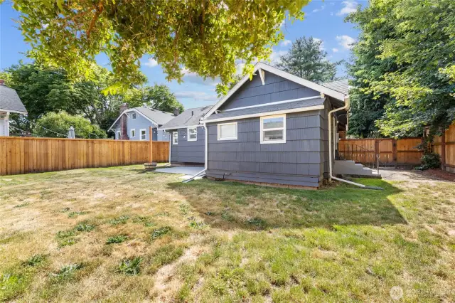 Fully fenced backyard with patio