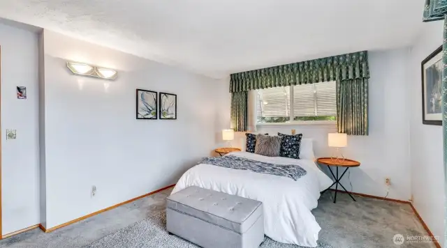 A generously sized primary bedroom with simple appeal, offering a comfortable retreat ready for your personal touch!