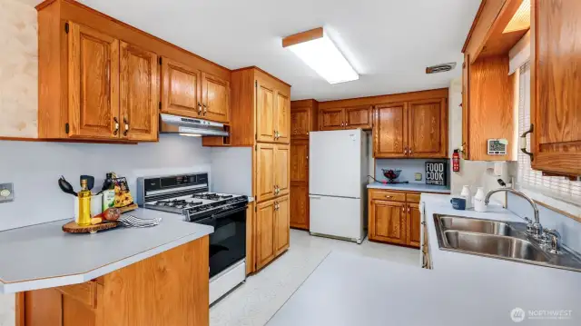 With abundant classic cabinetry and generous counter space, this kitchen is thoughtfully designed for those who love to cook and keep everything in order