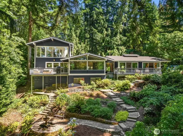 This distinctive multi-level home offers dynamic living spaces and a beautifully terraced backyard designed. Stone paths meander and lead to a central fountain.