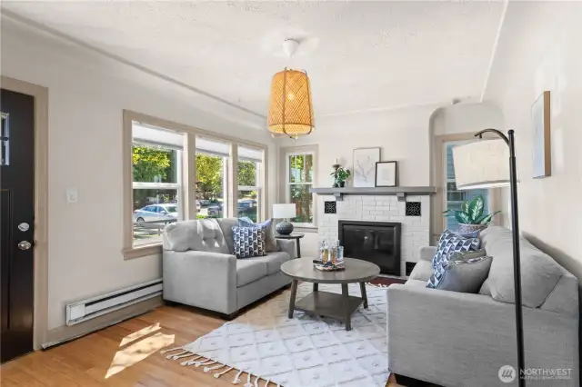 The wood-burning fireplace adds to the original character and charm of this classic Craftsman style home. Updated windows and custom blinds allow for privacy without sacrificing light. You will love spending your time in this delightful space.