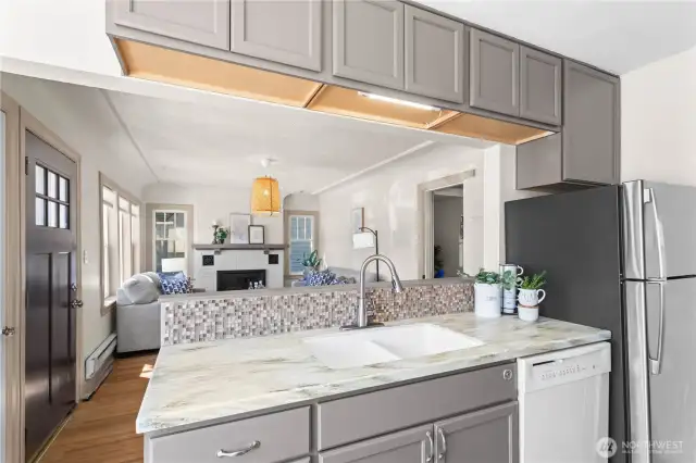 The updated kitchen has storage and counter space galore! Prepare a quick meal while keeping up with your guests stories from the living room.