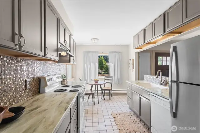 Cabinets were painted just a few years ago and still look brand new! A newer stainless steel fridge adds to the stylish ambiance of this great kitchen.