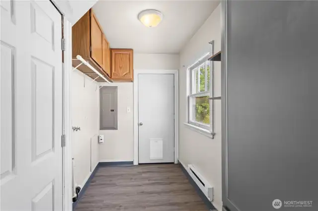 Off the kitchen is the utility room with storage cabinets and access to the back deck through the door in the center. LVP flooring in here makes for easy maintenance!
