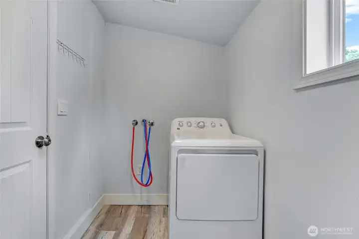 Laundry room with space for storage.