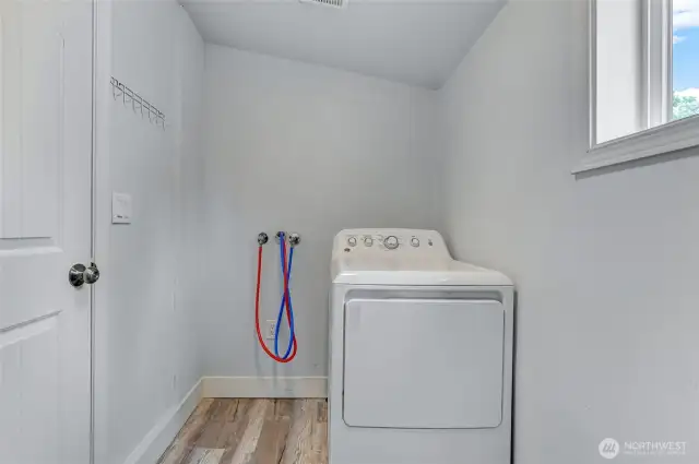 Laundry room with space for storage.