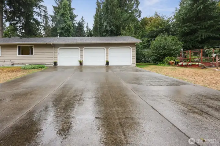 Large driveway to 3 car garage located on the side of the home