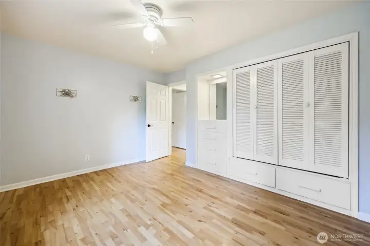 Bedroom two with built in closets and hardwood floor