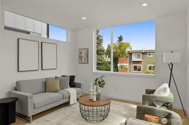 A seamless connection between indoors and outdoors highlights the thoughtful flow, with generous windows framing the tree-lined streetscape.