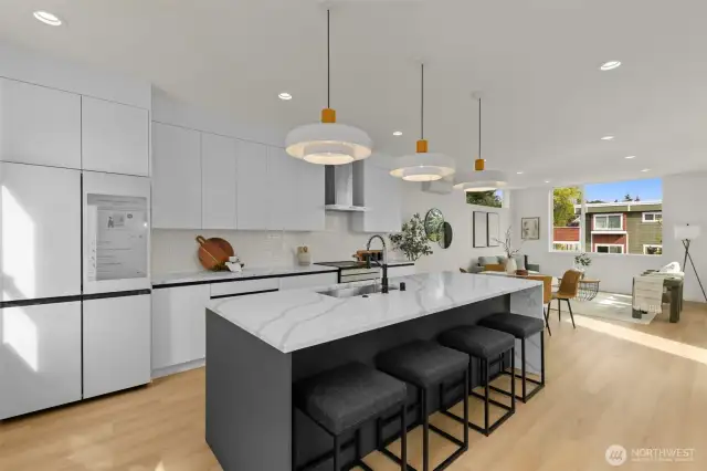 The chef’s kitchen boasts sleek custom cabinetry, premium appliances, and an expansive island designed to inspire culinary creativity.
