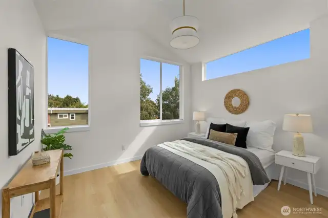 The primary suite offers a serene retreat with treetop views, oversized windows, and room to curate your ideal restful haven.