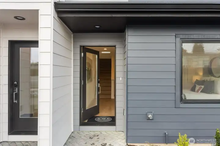 The front entry is framed by clean detail and warm tones, offering a stylish first impression before you step inside.