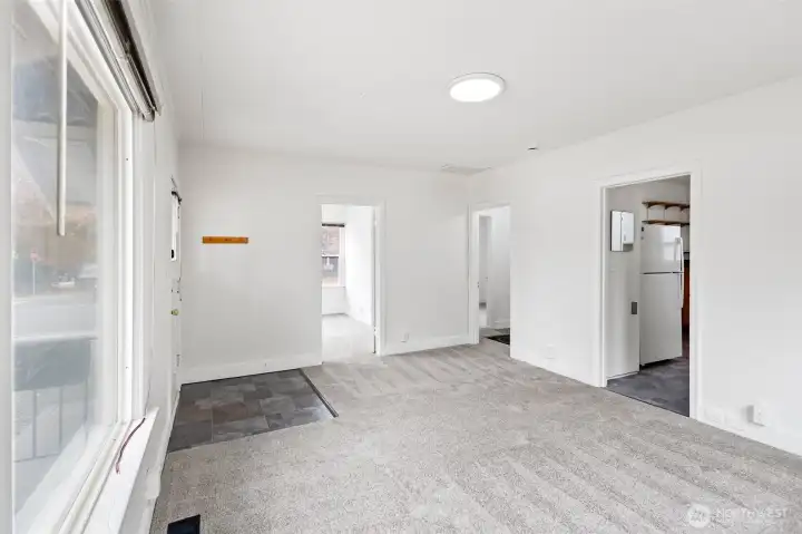 First bedroom on the left, hallway to bath and second bedroom in the center, kitchen to the right and basement stairwell to the right.