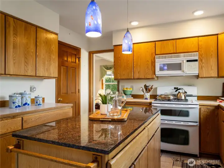Very functional kitchen with solid oak cabinets and granite countertop on the island.