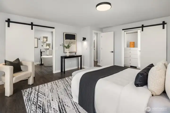 Dual barn doors maximizing the space leading to bathroom and walk-in closet.