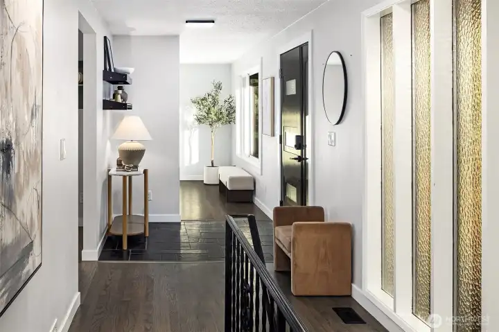 View of the foyer with its slate flooring and staircase leading to the ground level.