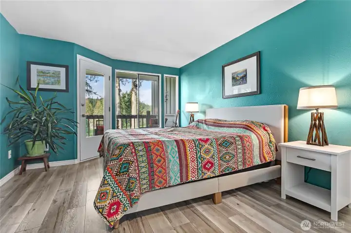 Primary bedroom with separate door to balcony.