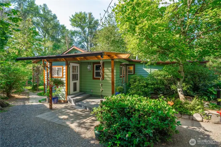Private, shaded patio area nestled among mature trees and plants