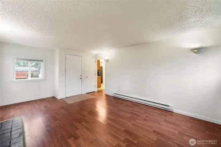 Spacious main living room area featuring durable flooring abundant light, and flexible layout options.