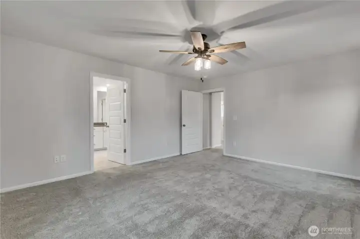 Primary suite angle showcasing the entrance to the private ensuite.