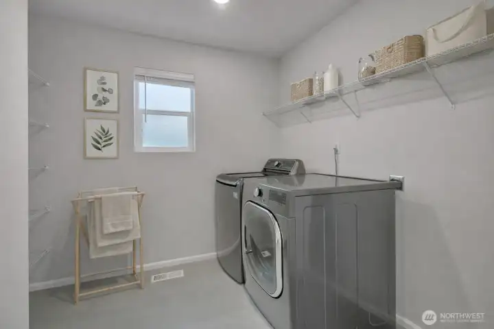 Convenient upper-level utility room -virtual staged.