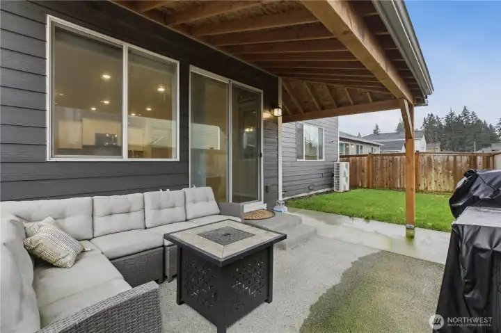Inviting covered patio with a fully fenced backyard for privacy and comfort.