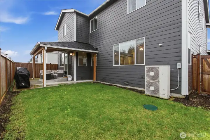 Alternate view showcasing the backyard and covered patio.