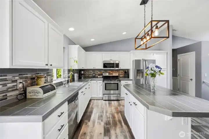 Stainless steel appliances and tones of prep space, including the island with storage!