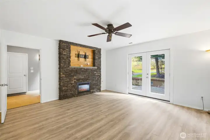 Rec room has a beautiful stone surround fireplace.