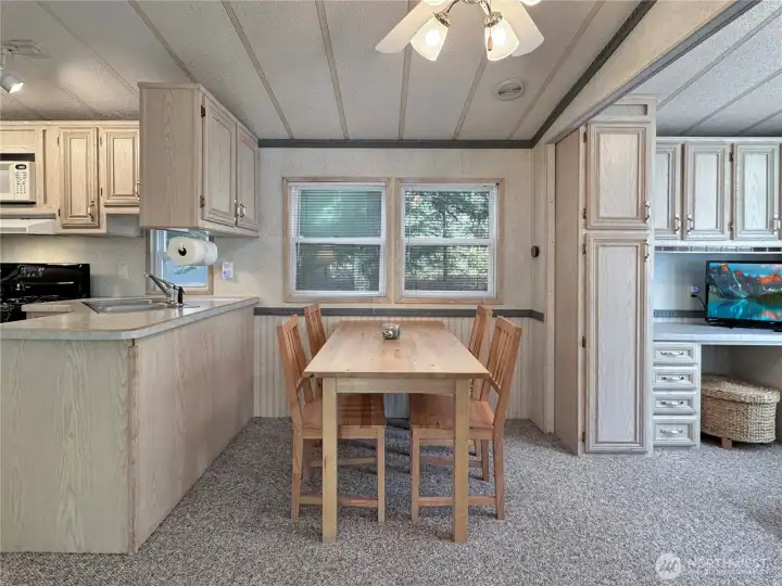 Dining area is positioned neatly along the back wall allowing for an open flow of the main living space