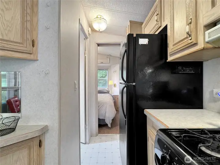 Hall from kitchen to bathroom and primary bedroom