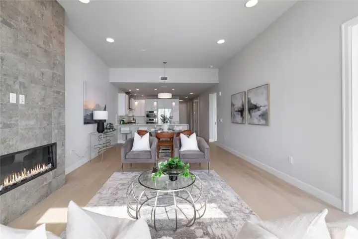Open-concept design with soaring ceilings across the living room, dining area, and kitchen