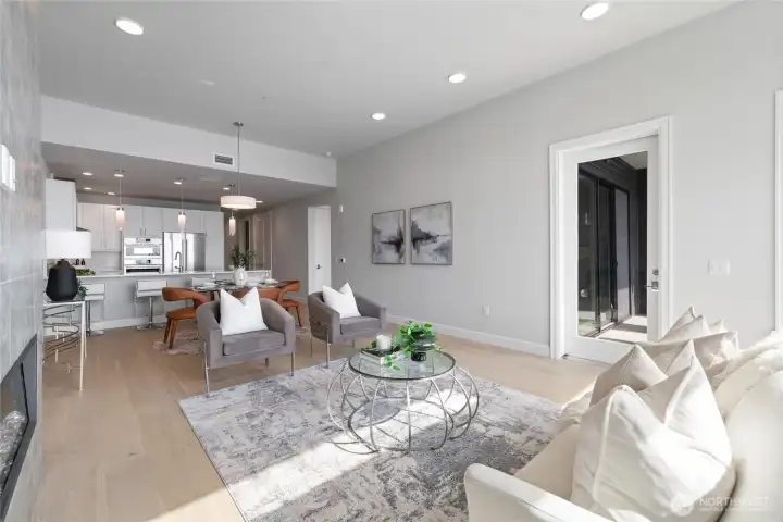 Open-concept design with soaring ceilings across the living room, dining area, and kitchen
