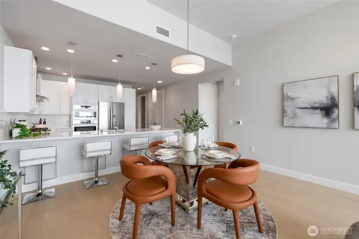 Spacious kitchen with eating bar and dedicated dining area, perfect for entertaining