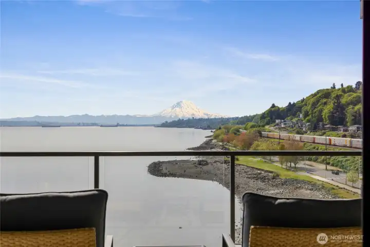 Seamless balcony access from the primary bedroom with postcard-worthy Sound and mountain views