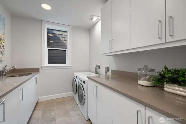 Large laundry room with brand-new washer, dryer, and utility sink