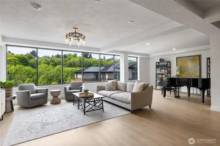 Expansive entertainment lounge featuring a pool table, grand piano, two kitchens, flexible party spaces, multiple seating and dining areas, plus outdoor deck and BBQ area