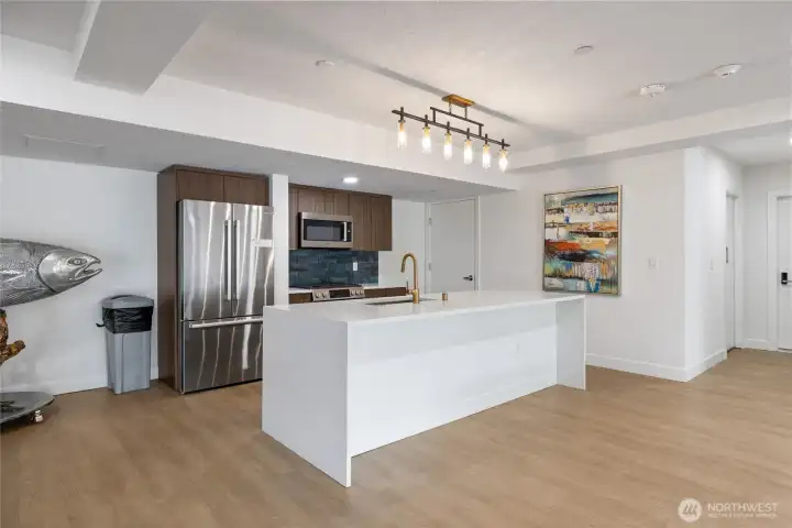 Expansive entertainment lounge featuring a pool table, grand piano, two kitchens, flexible party spaces, multiple seating and dining areas, plus outdoor deck and BBQ area