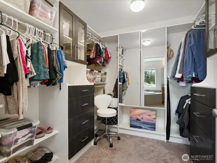 Primary suite's walk-in closet showcasing the custom built organizers.