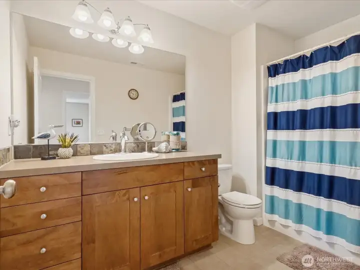 Upstairs hallway bathroom with a tub.