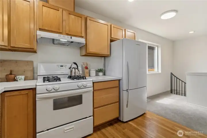 Gas stove? Yes, please... check! And that black railing in the corner leads to one of this home’s best practical surprises: secure access to your parking space in the shared garage downstairs.